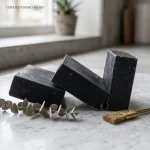 Activated charcoal soap bars in natural bath setting