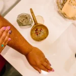 Botanical body scrub applied during gentle exfoliation