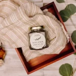 Botanical body scrub jar in self-care gift setting