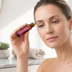 Woman using soothing roll-on with organic coconut oil